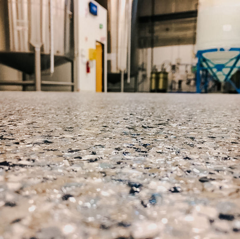 Urethane and epoxy flake flooring for manufacturing facility by Champion Coatings
