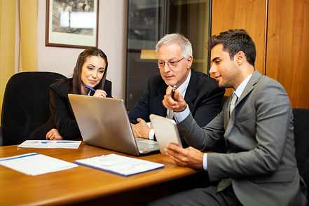group-businesspeople-discussing-while-looking-laptop-screen.jpg