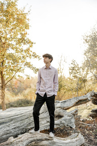 fall teen standing on a log