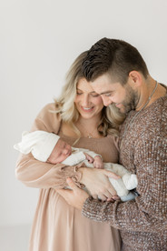 parents holding baby