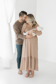 parents holding baby