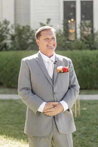 groom watching bride walk in