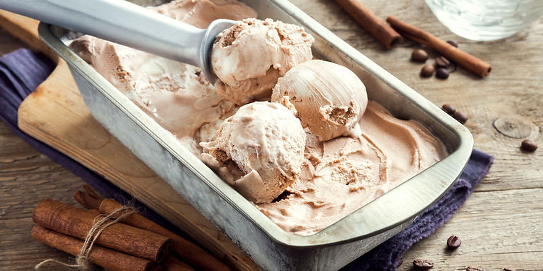 allergy free recipes - a homemade tin of icre cream and an ice cream scoop scooping some out.