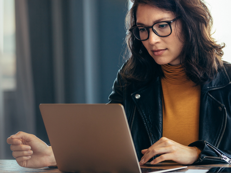 Small-business owner reviewing AI bookkeeping for small business records and financial evidence on a laptop