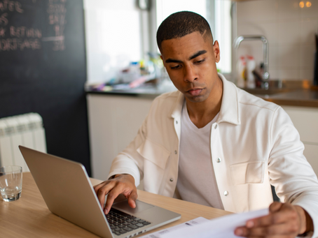 Google AI Mode SEO research by a business owner working at a laptop