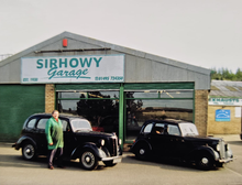 Front of Sirhowy Garage, with classic cars parked outside