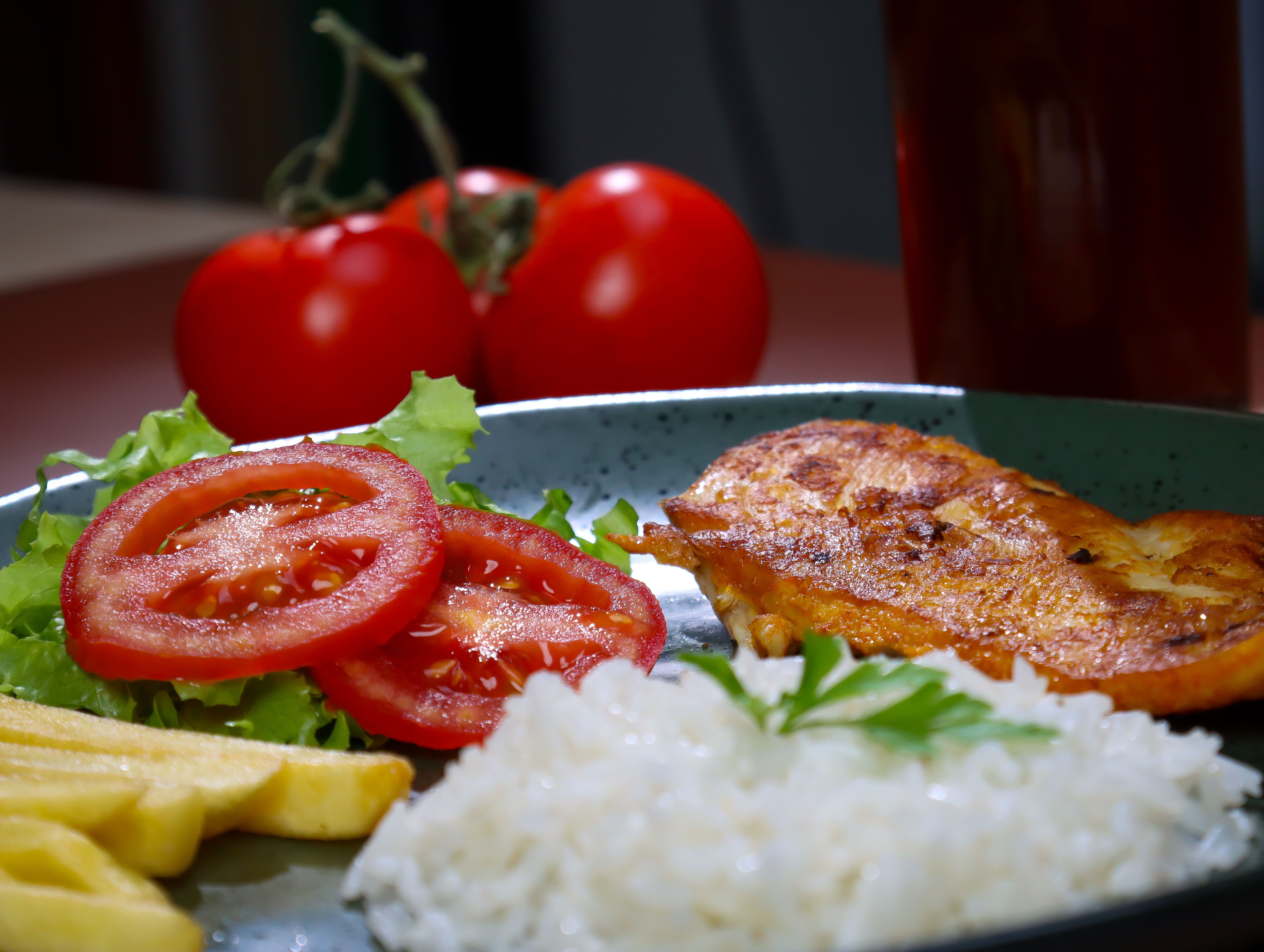 Grilled chicken plate with rice and vegetables; illustrative lunch photograph