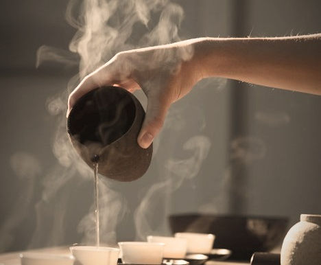 a hand pouring warm water out