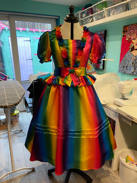 Rainbow coloured dress with full skirt and bows