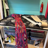 Workbench at Curious Studio showing the mid process of a sewing project to make colourful fabric blind covers