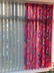 Photo of a set of grey blinds, half of them covered with fabric