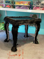 An upcycled table with velvet, faux fur and corset legs