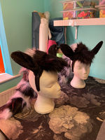 Two zebra headdresses on hat stands
