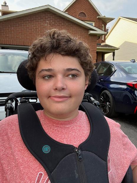 Here’s a bit about Cédric, or as we call him The Dude, and his journey (in Ontario, Canada).

Very early on, we noticed that Cédric was not reaching milestones at the same pace as his peers. By 18 months old, we were able to consult a developmental therapist, a physiotherapist and a speech and language pathologist. They confirmed delays in all areas and we started therapies and a quest for a diagnosis.

We first got, with difficulty, a diagnosis of developmental delay which allowed him to start school with the help of an Educational Assistant. We had to keep pushing and eventually got an autism diagnosis which opened doors to funds and services. This was our reality and our sense of Cédric’s identity for years, but we always felt he was still a special case within that group.

After he started having epileptic partial seizures at 9 years old, genetic testing was done and we received a DLG4 frameshift mutation diagnosis in November 2018, just before he turned 11. And this has felt like coming home, like finding him and his identity, as it medically explains all his challenges. It also allowed us to find our family in the small but mighty community of other families affected by DLG4 mutations.

In Cédric’s case, the mutation causes a severe intellectual disability, neurodiversity (autism) and epilepsy. He is very hyperactive, anxious, non verbal, not toilet trained, hypermobile and low tone, and had gastro- intestinal issues. And his epilepsy has been a difficult new challenge as his seizures are hard to control and are drop seizures (which paired with no sense of danger, bad motor control and hyperactvity is a bad combo).

With all that said, Cédric is a generally happy, pretty easy going and very affectionate guy who gives the best hugs and kisses. He loves anything sensory stimulating (car rides, swings, trampolines, roller coasters, music), especially water (swimming, showers, baths). Our happy place is definitely Disney World. And he is literally diagnosed in black and white as charming and handsome (by the psychiatrist on his autism diagnosis) which he uses to get away with quite a lot!