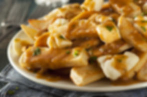 poutine - french fries covered with gravy with cheese curds on top