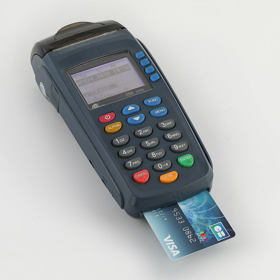 A credit card inserted into a payment terminal, representing the merchant-processing controls in the Nuvei FTC settlement