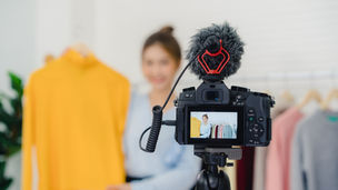 Fashion creator filming with shopping bags as TikTok lifestyle LARPing turns aspiration into content