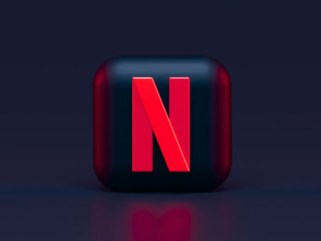 YouTube logo displayed on a phone beside other social media apps