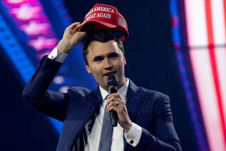 Charlie Kirk, Turning Point USA founder, puts on a MAGA hat during the AmericaFest 2024 conference sponsored by conservative group Turning Point in Phoenix, Arizona, U.S. December 19, 2024. REUTERS