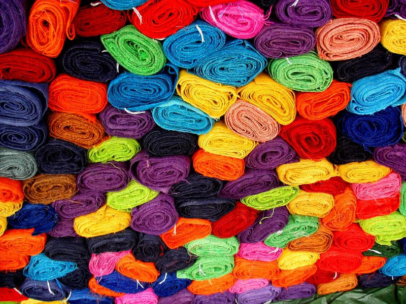 Rows of colorful fabric swatches used to compare clothing colors in personal color analysis