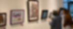 Two people enjoying art at an exhibition.