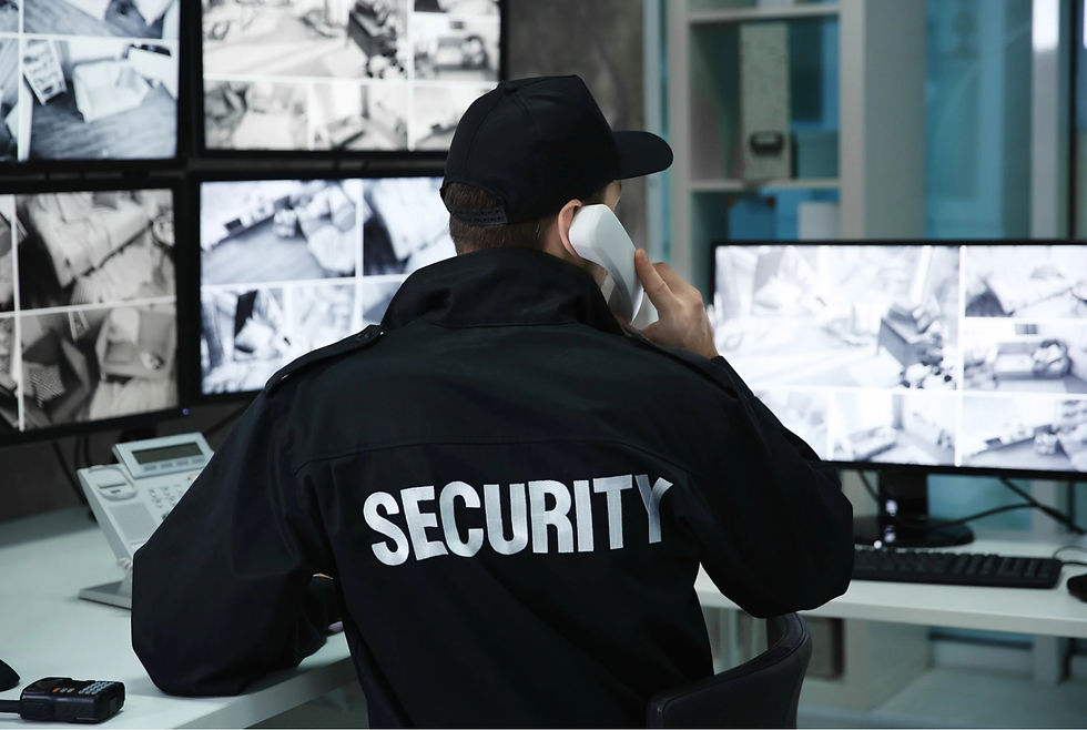 Security officer monitoring surveillance footage in a control room while responding to a call.