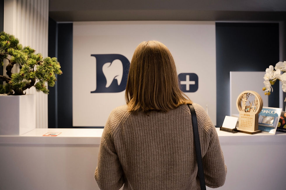 A woman stands at a front desk in a professional office, representing how social engineering often begins with trust, routine, and non-threatening behavior.