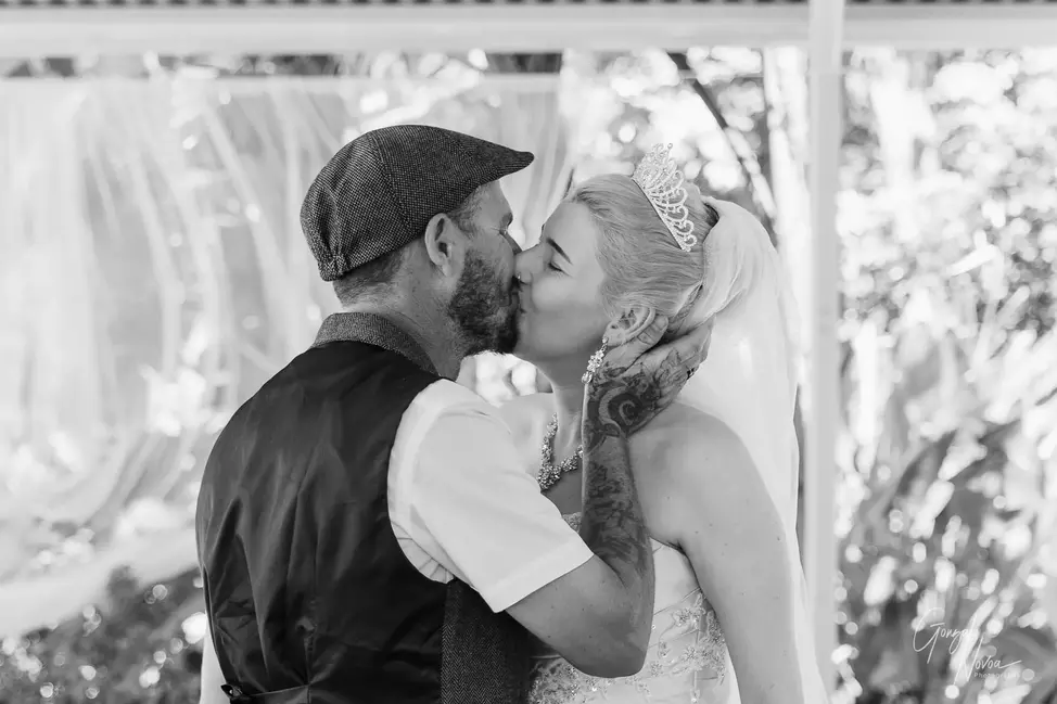 Bride and groom sharing their first kiss during their wedding ceremony at a private property in Karnup, WA.