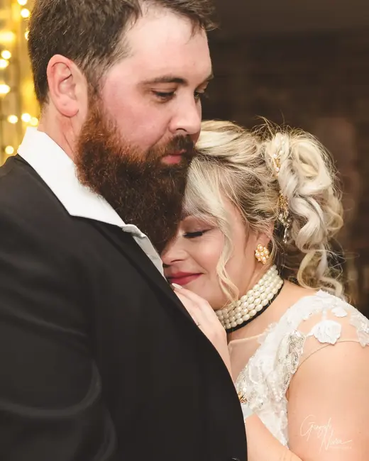 Bride resting her head on groom’s chest during an emotional moment at The Guildford Hotel in WA.