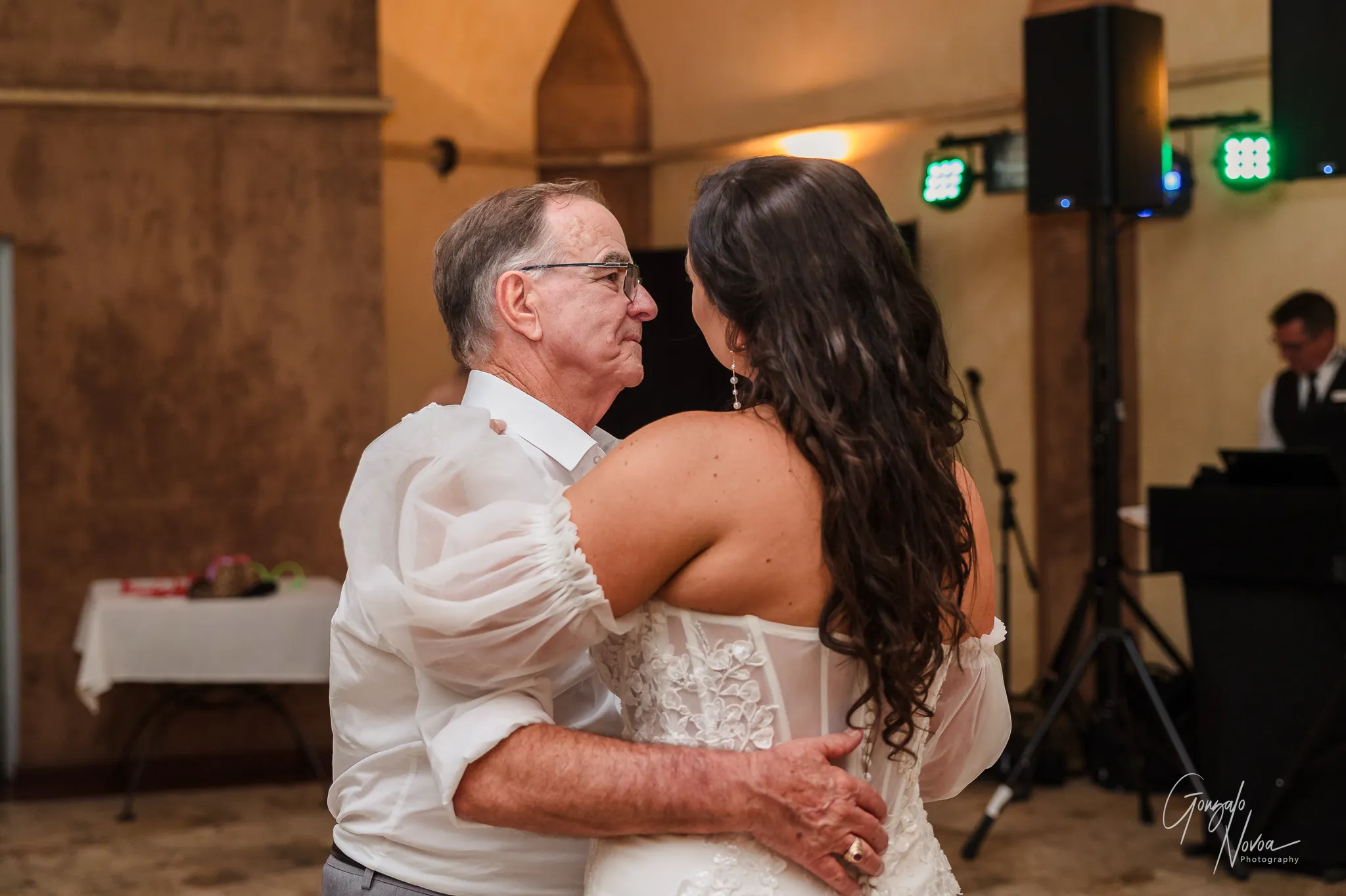 The bride shares a sweet father-daughter dance at her Sittella Winery wedding reception, both smiling softly as they hold each other close on the dance floor.
