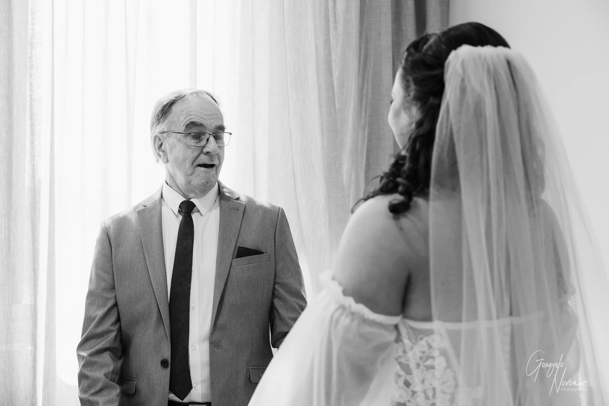 Black and white photo of Tahnee’s father reacting with emotion and pride as he sees his daughter in her wedding dress during their heartfelt first look.
