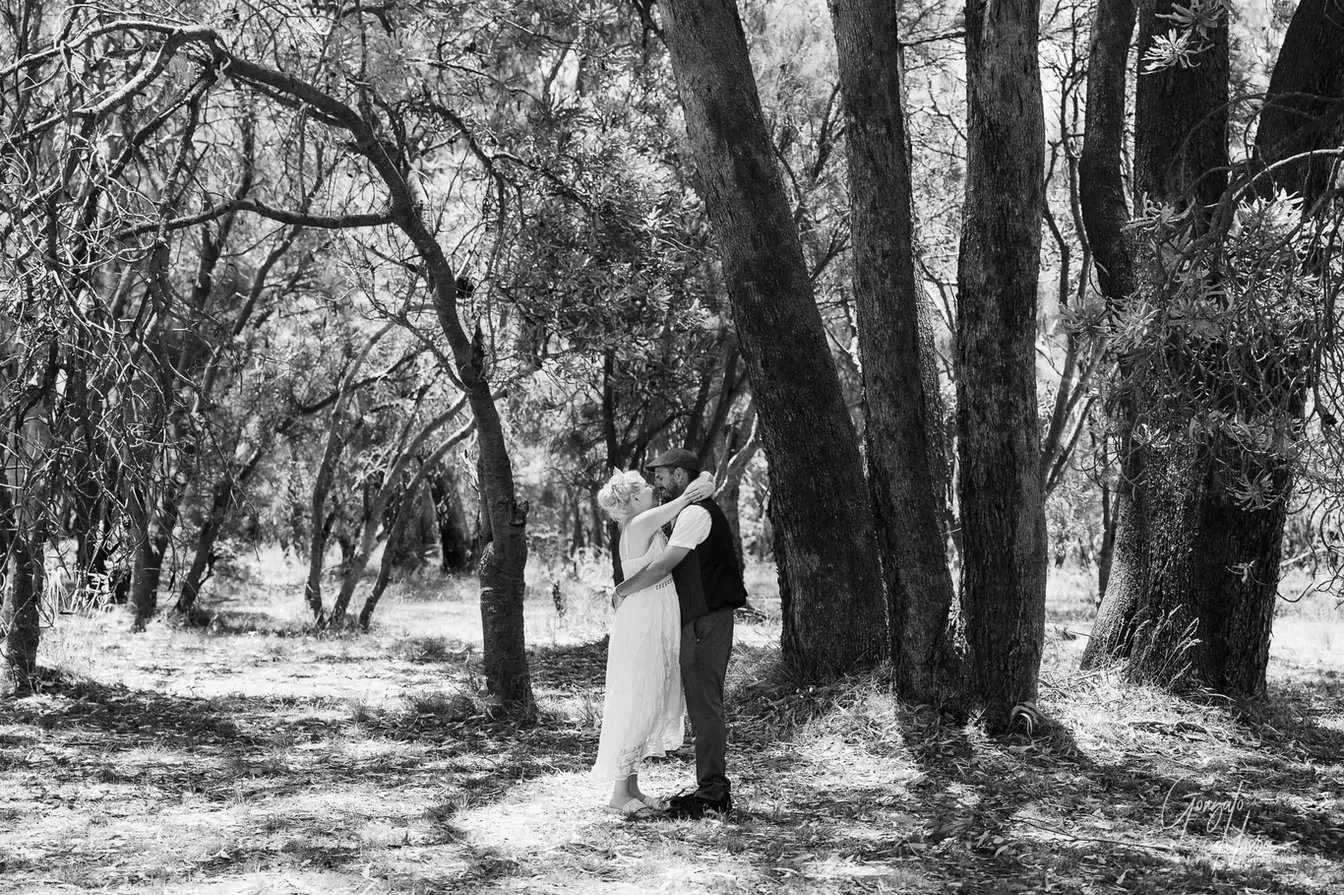 Couple embracing in a forest setting at a private property in Karnup, WA.