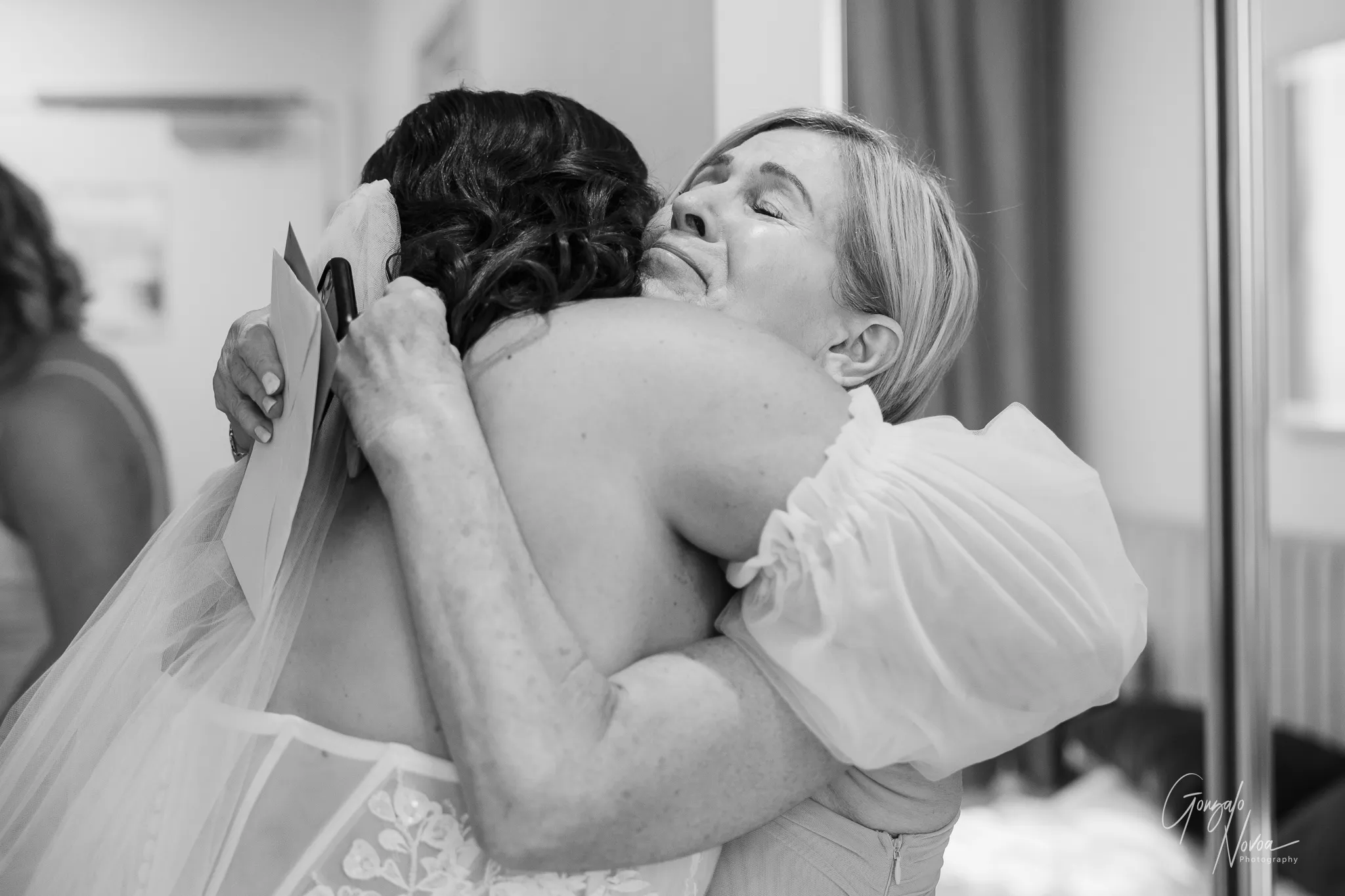 Black and white photo of bride Tahnee hugging her emotional mum tightly, capturing a heartfelt moment before the wedding ceremony.