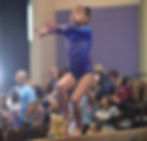 gymnast posing on beam