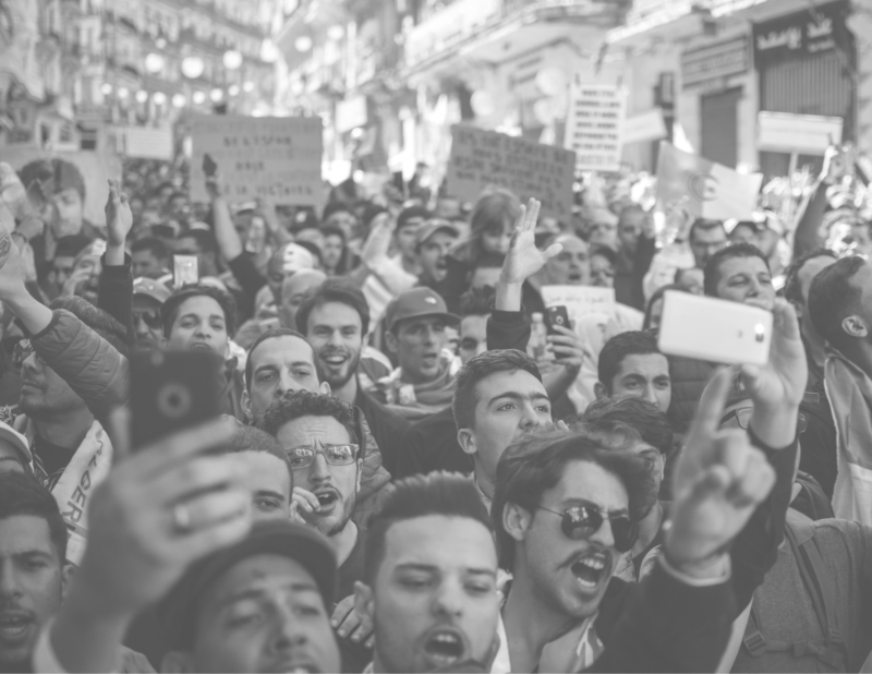 A black and white image of a crowd of people at a rally