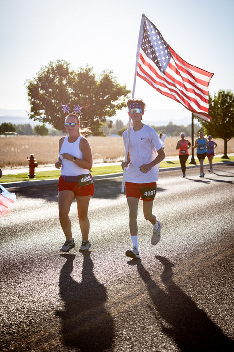 Two racers carrying an American flag