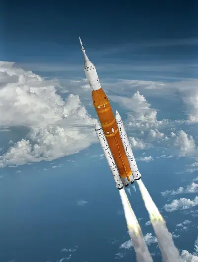 Artemis SLS Rocket by NASA launching up through clouds into outer space.