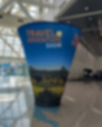 Cone shaped sign for leading to Travel and Adventure Show tips