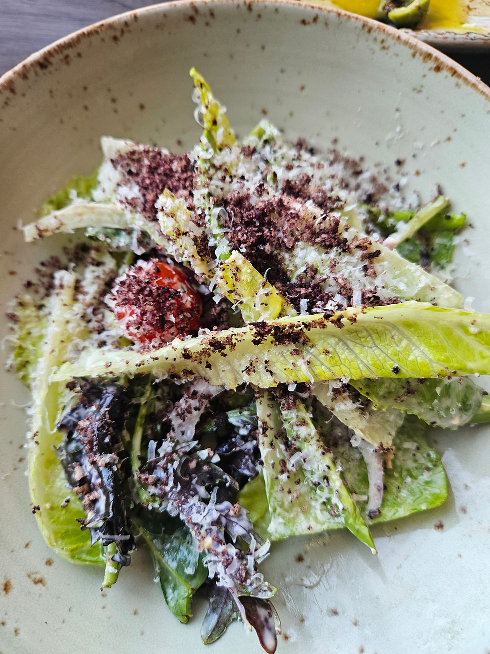 Salad with endive lettuce and with crumbles of black olives
