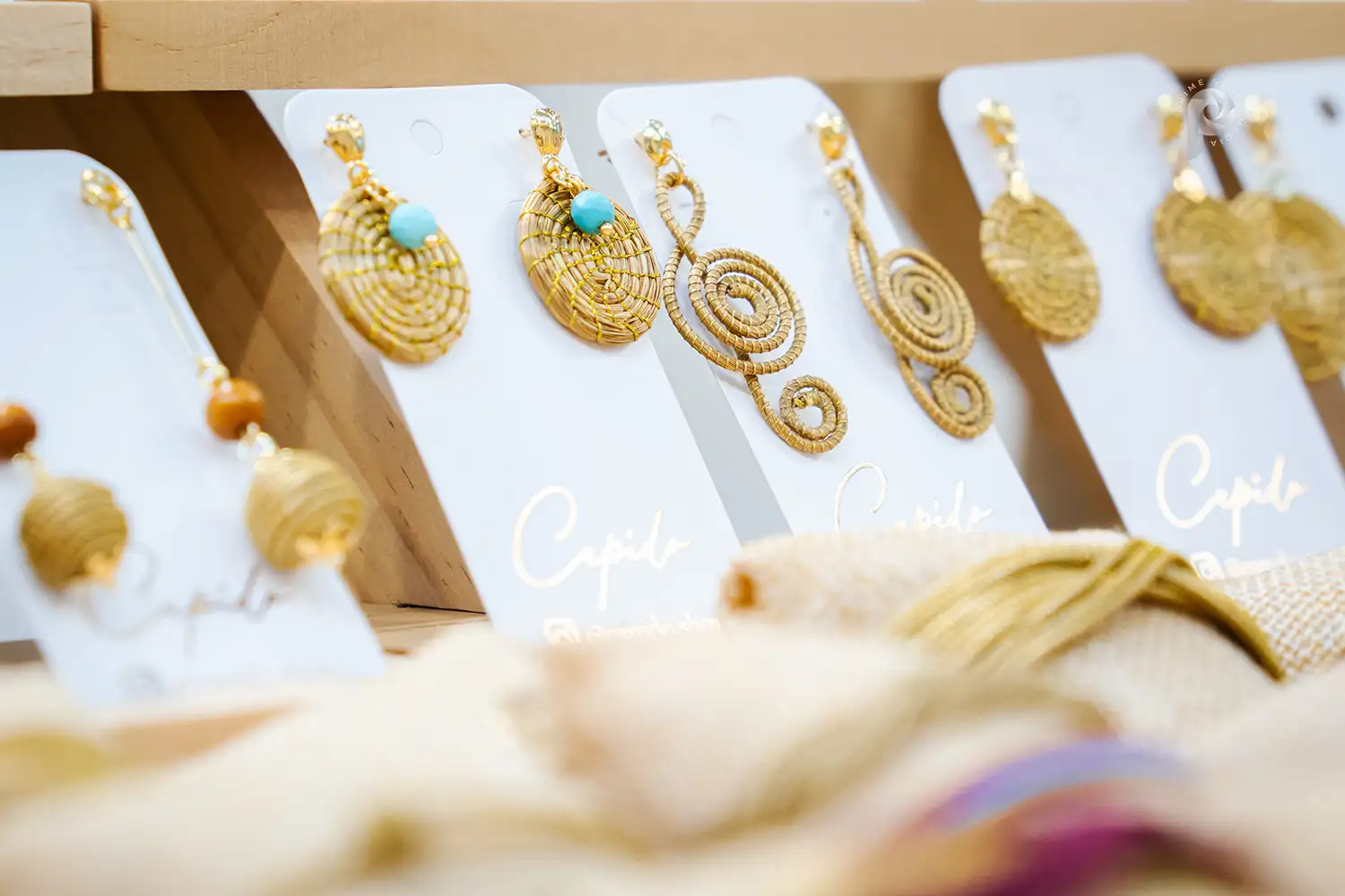 Image of gold-colored earrings made from natural fibers in Brazil