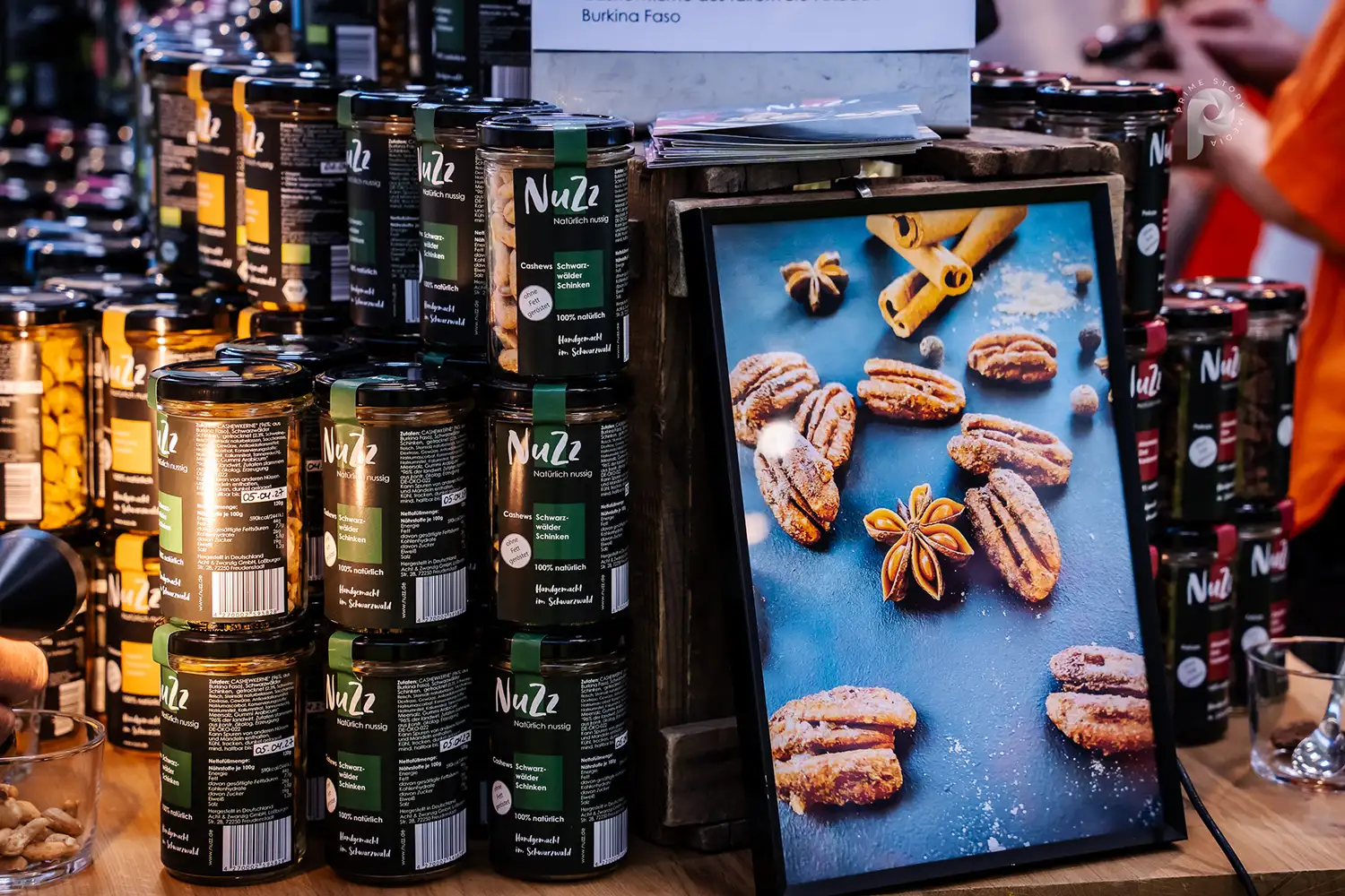An image of various types of peanuts, including various flavors, in glass containers.