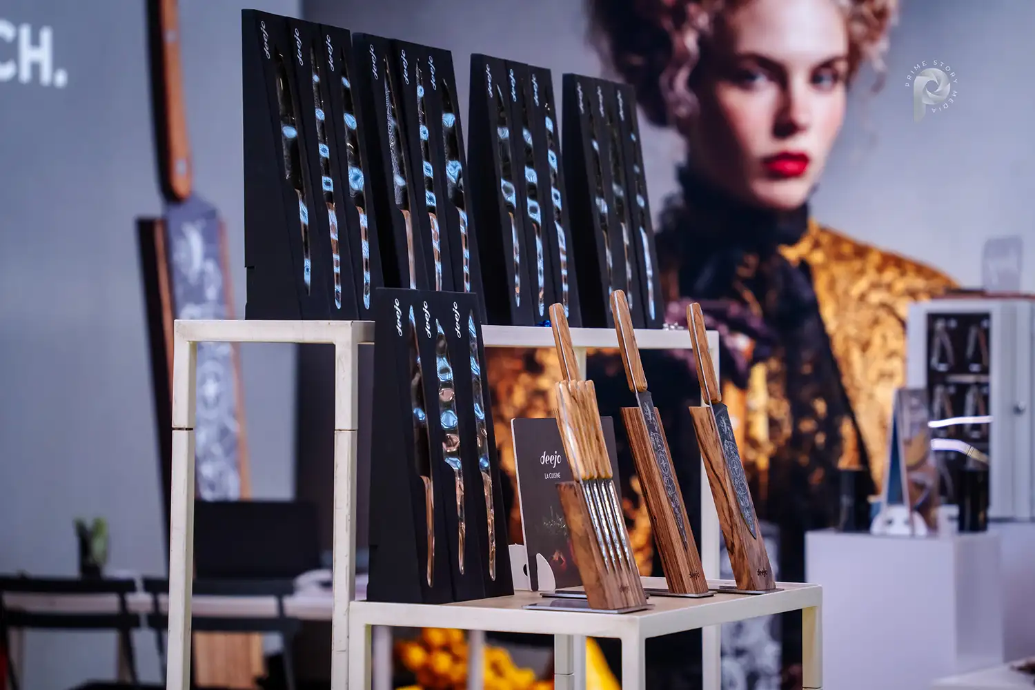 A view of a custom-designed knife stand with a woman's face in the background