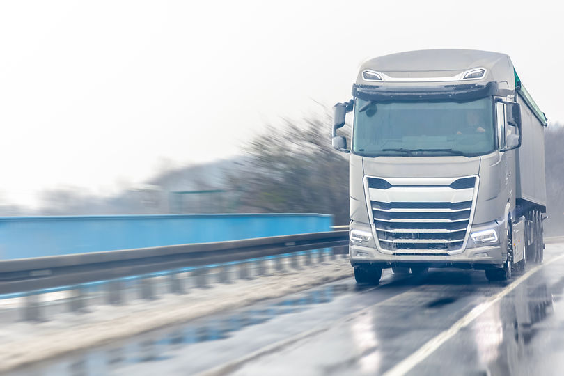close-view-truck-wet-winter-highway-with-spray-powerful-delivery.jpg