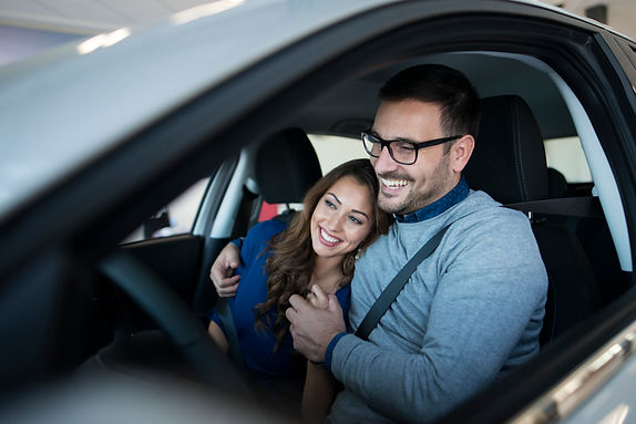 happy-young-couple-enjoying-their-brand-new-car.jpg