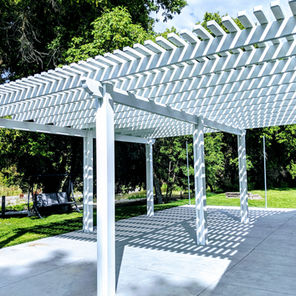 A white pergola or lattice awning with slats to offer shade while allowing light and breeze through.