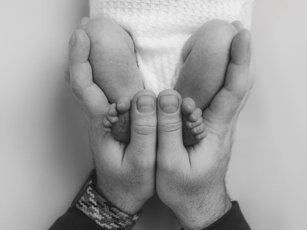 Baby feet held in hands