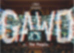 Glitchy multicolor screen wall in a theater; Festival de Cannes Compétition Immersive 2026 and v. The People text.