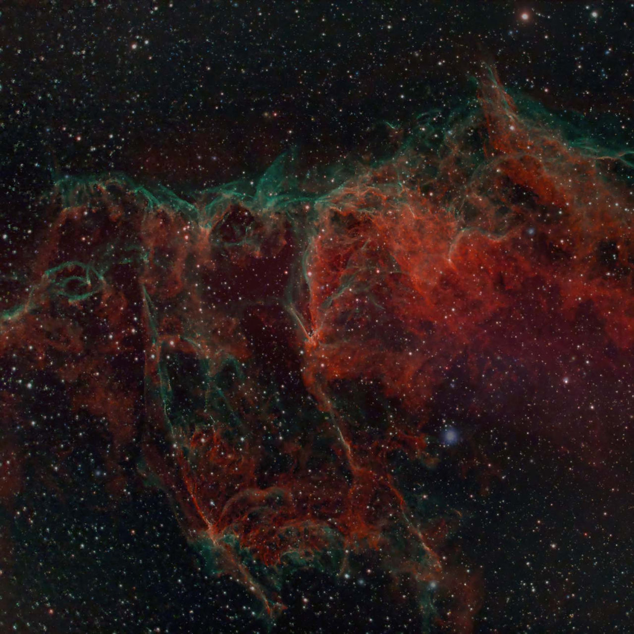 Nebula with swirling red and green clouds set against a starry night sky, creating a cosmic and ethereal atmosphere.