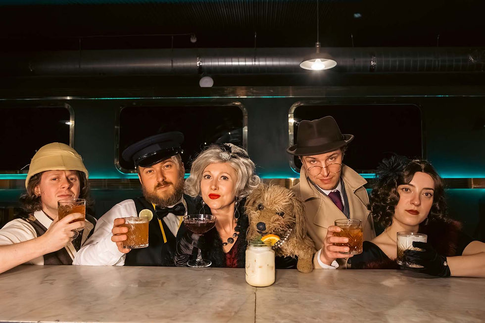 Vintage-dressed group at a dim bar raises cocktails, with a dog at center, in a moody retro lounge.