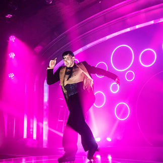 A person on rollerblades performs on stage